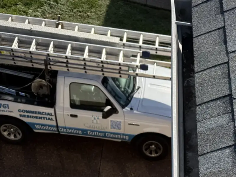 A Camelot truck in the driveway of a Nashville home during a gutter cleaning
